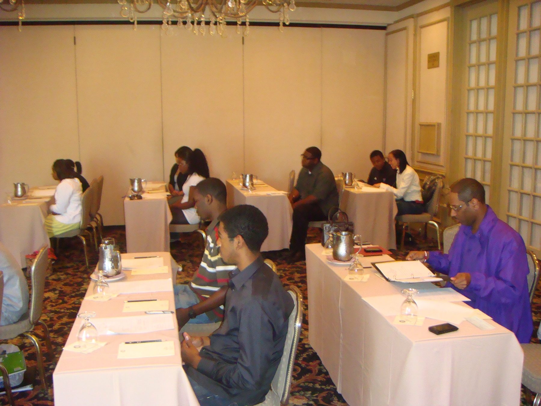 Academy participants seated at a formally set etiquette dinner table