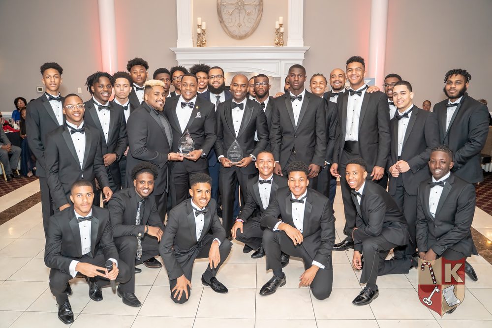 Beautillion mentors and honorees celebrating together in tuxedos, Class of 2019